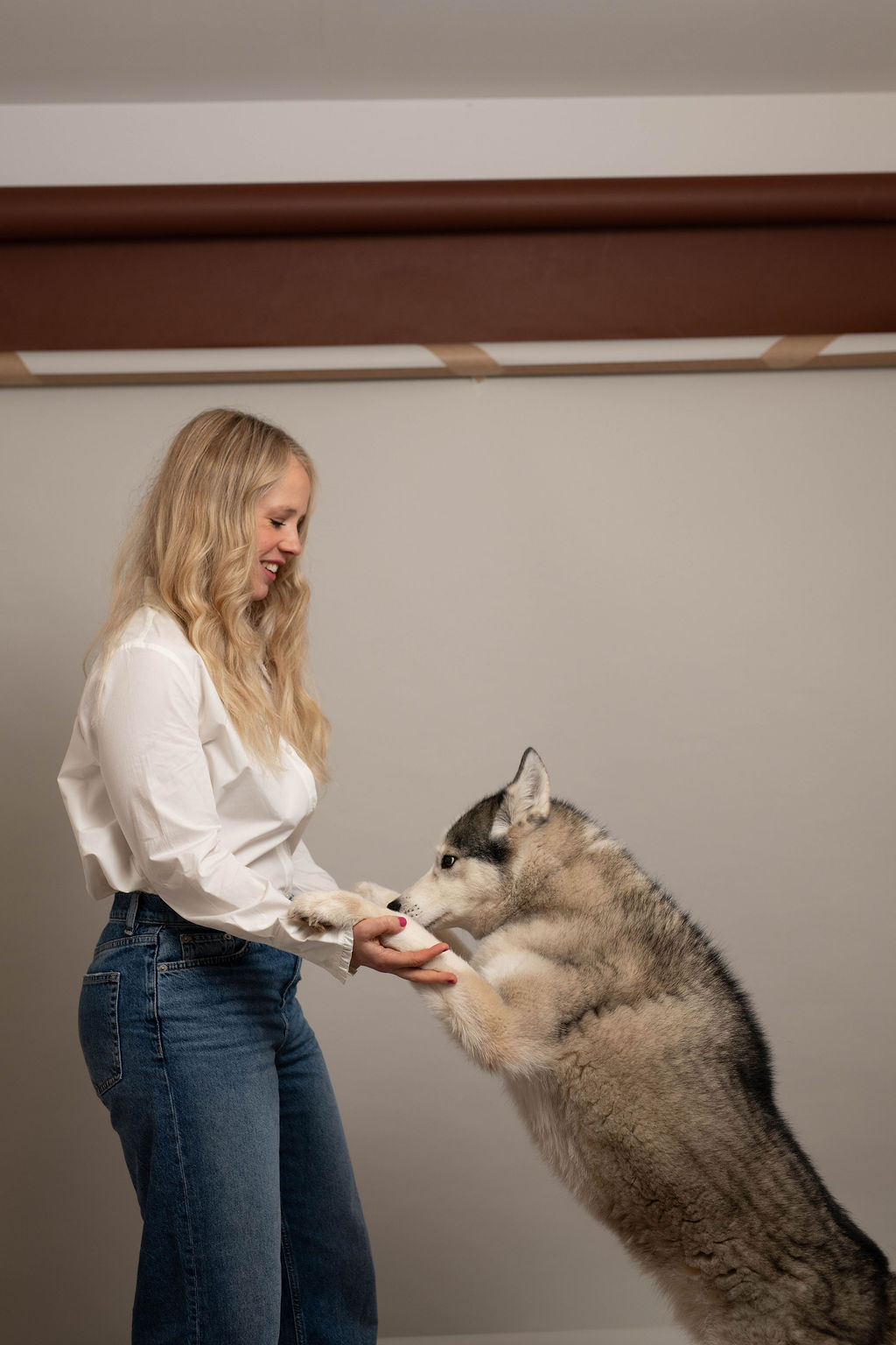 The Lone Wolf handler with her husky standing up on its hind legs, paws in her hands